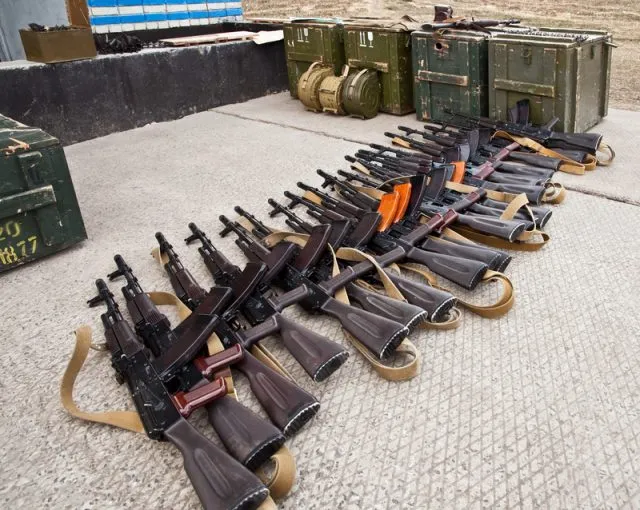 A pipe of confiscated guns lined up on the floor