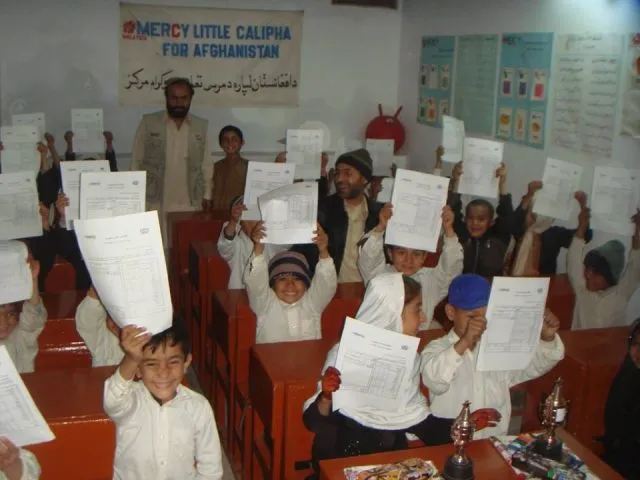 A classroom of children happy cheering their work