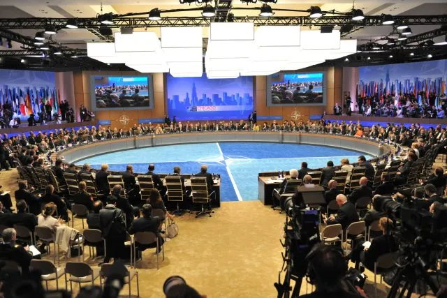 People gathered in a room at the NATO Chicago Summit in May 2012