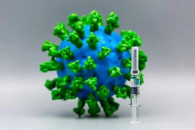 Virus as a globe with a vaccine