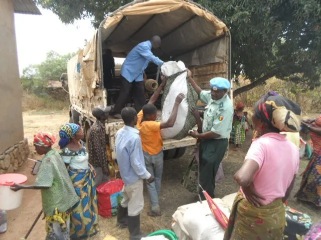 A group of people unloading supplies from a van