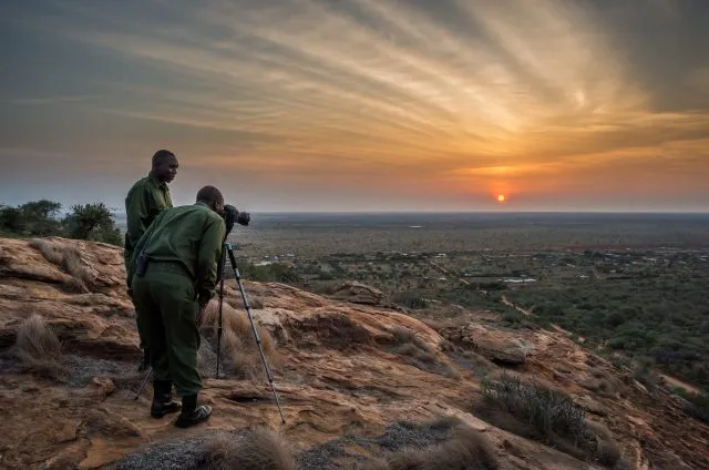 Wildlife rangers photographing the sunset