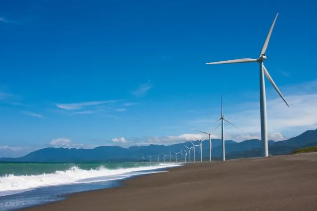 A philippine beach with windmills