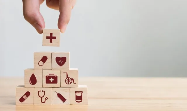 Wooden blocks stacked into a pyramid with health symbols on them