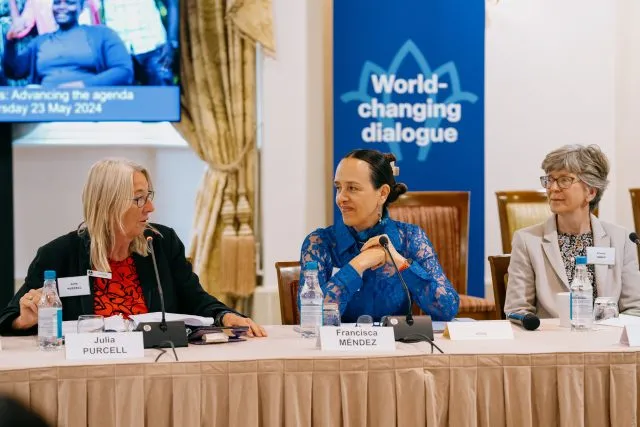 Julia Purcell, Wilton Park programme director; Francisca Mendez Escobar, Mexican Ambassador to the UN Office in Geneva; and Penny Innes, Head of the FCDO Disability Inclusion Team, smile as they sit at the conference table.
