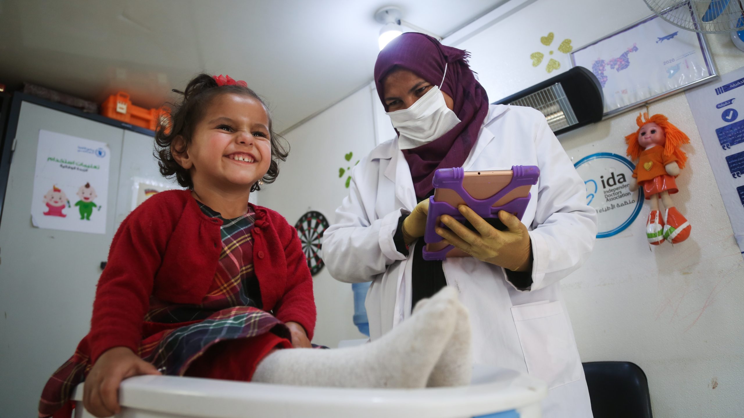 Female,Doctor,Weighting,Cute,Baby,In,Clinic.,Aleppo,,Syria,October