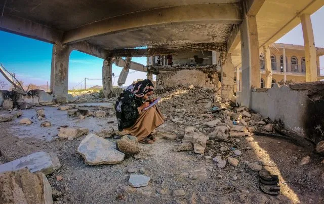 Taiz / Yemen - 01 Apr 2019: Hanan is a student who has dropped her classes in her school, which has become a wreck because of the war in Yemen. She is sitting in the ruins of the classroom.