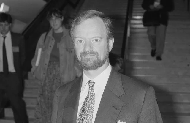 Robin Cook looking to camera in black and white.